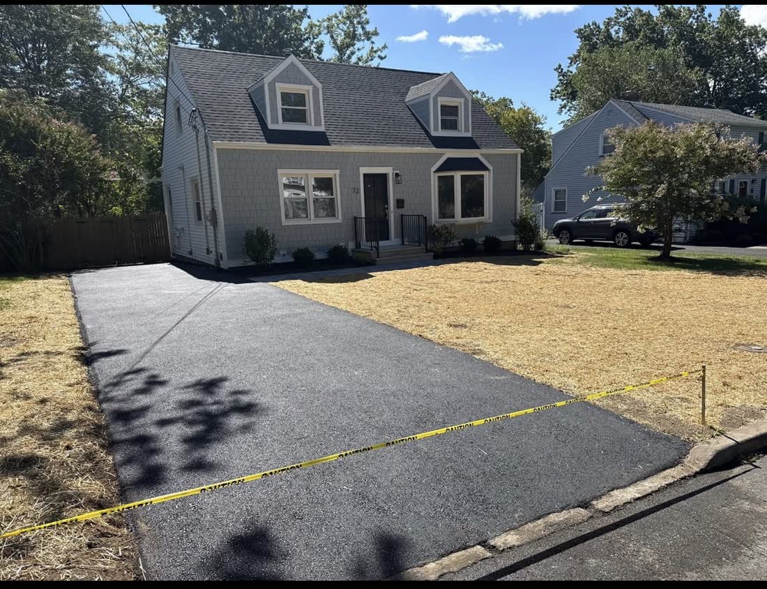 Cape Cod style home with a new asphalt driveway